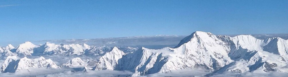 A range of snow-covered mountains under a clear blue sky. 4