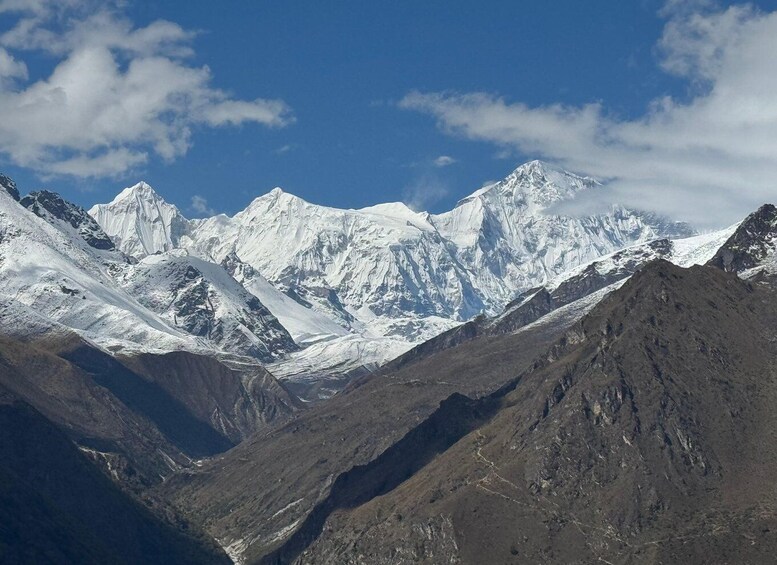 A range of snow-capped mountains under a clear sky. 3