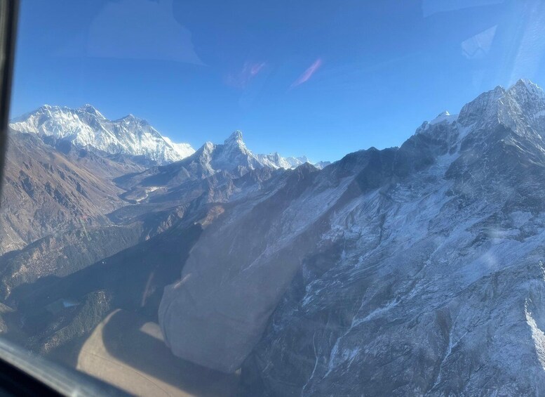 A mountainous landscape with snow-covered peaks and a winding road. 4