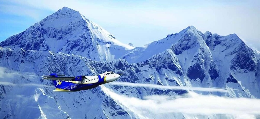 An airplane flying over snow-covered mountains. 5