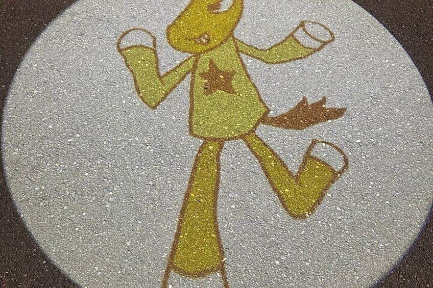 A circular, textured surface with a yellow figure holding a cup. 3
