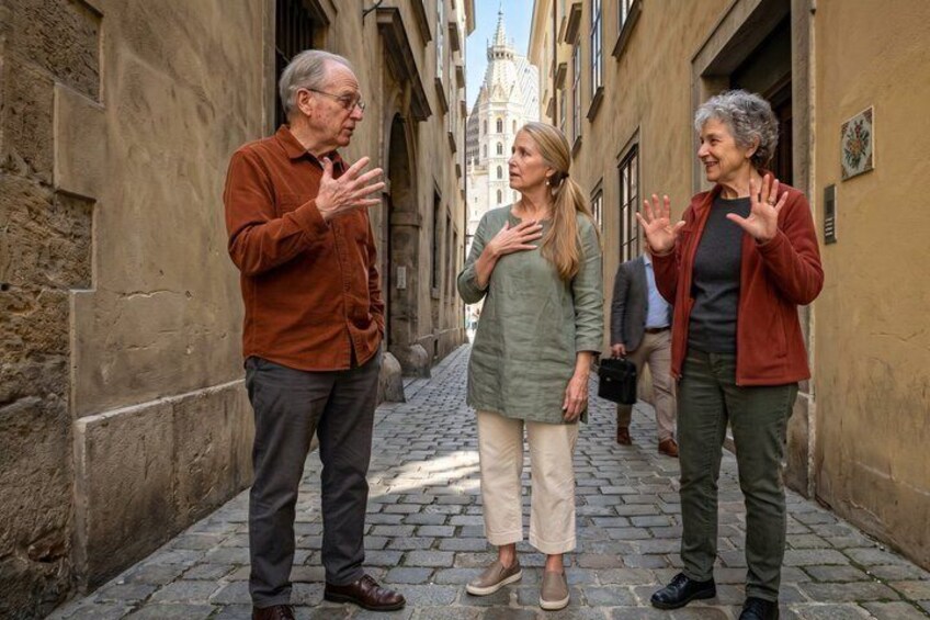 A narrow street with historic buildings, a person gesturing, and another person with a blurred face. 1