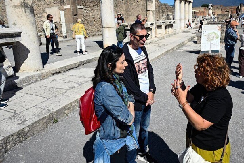 Tourists at an ancient archaeological site with ruins and columns. 1