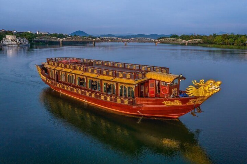 A traditional red boat with golden dragon head on a river. 5