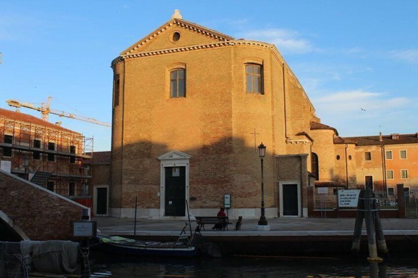 A historic building with a port and a crane in the background. 2