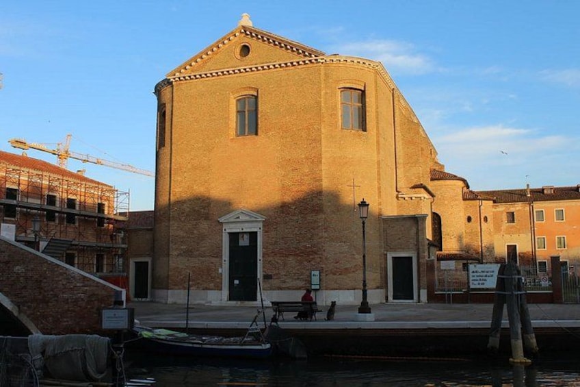 A historic building with a port, a crane, and a boat. 2