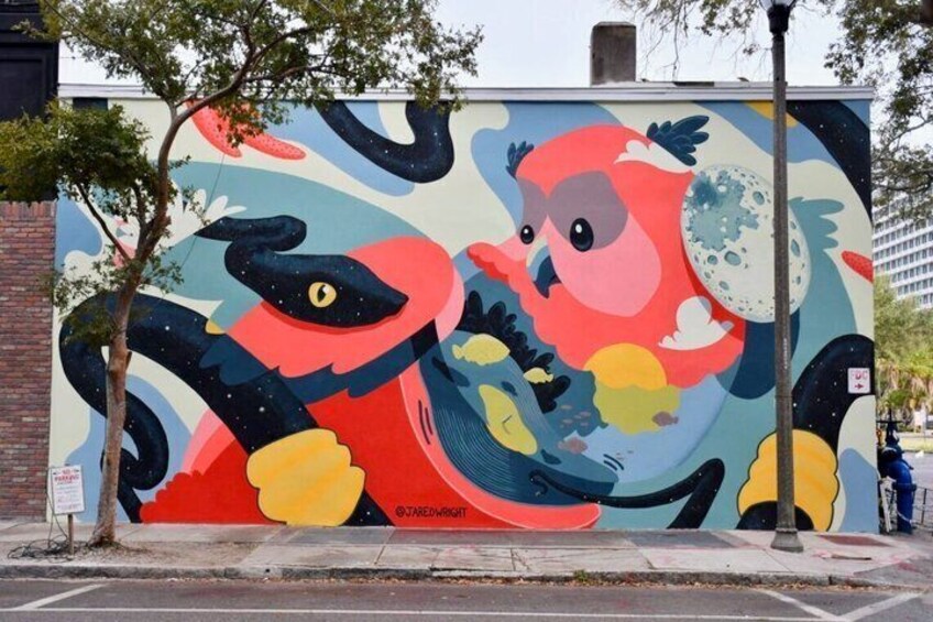A colorful mural of a bird on a wall. 2