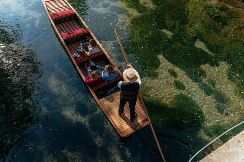 A rowboat with passengers and a guide on a clear river. 5