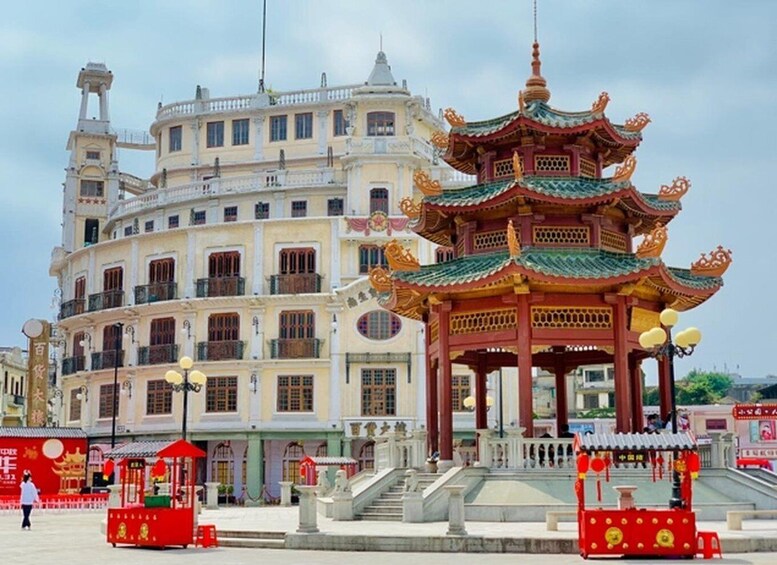 A traditional Chinese pavilion with ornate architecture, a multi-story building with balconies, and a clear sky. 3