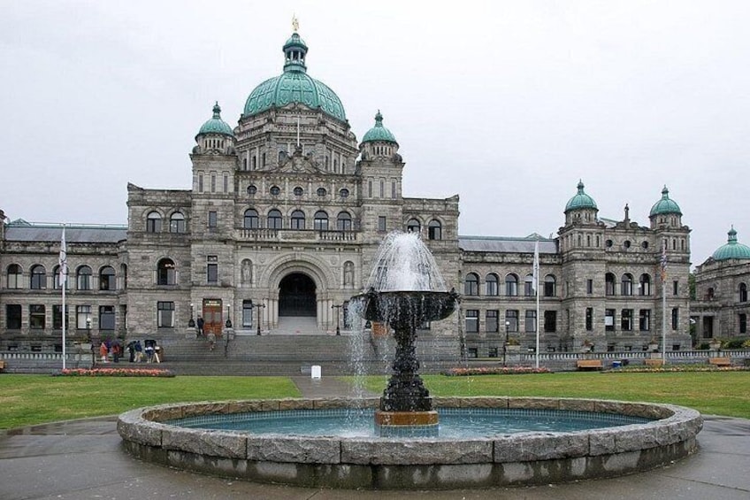A historic building with domed architecture and a fountain in front. 5