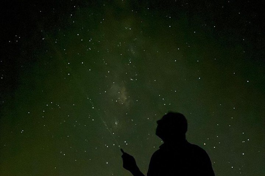A silhouette of a person gazing at a starry night sky. 2