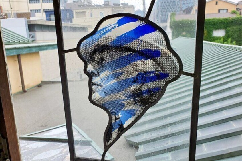 A stained glass window with a blue and white pattern. 5
