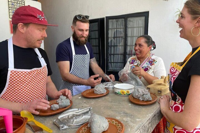People preparing food outdoors with bowls, plates, and cooking utensils. 1