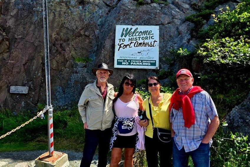 A group of people standing in front of a sign that reads 'Welcome to Historic Fort Amherst.' 3