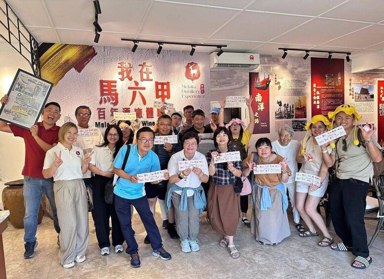 A group of people holding certificates in front of a wall with Chinese text and a logo. 2