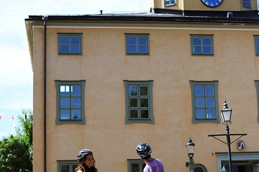 A building with multiple windows and a clock on the facade. 2