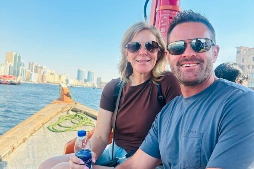 Two people on a boat with a city skyline in the background. 3