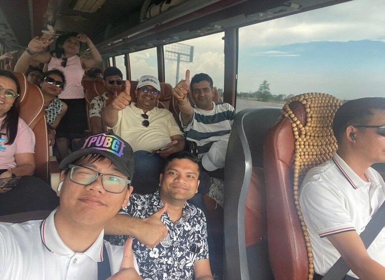 A group of people on a bus with a scenic view outside the windows. 1