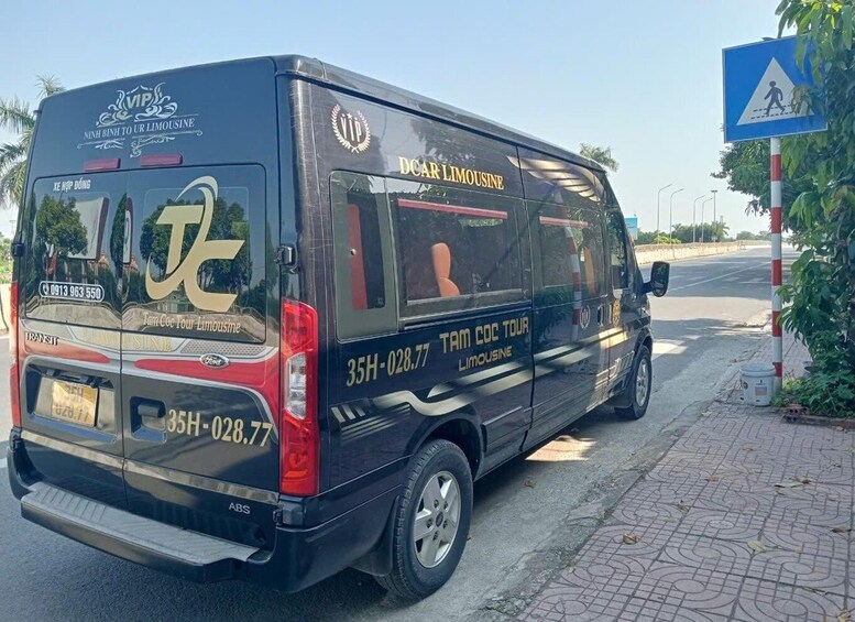 A black van with 'VIP' and 'DCA R LIMOUSINE' on the back, parked on a street. 3
