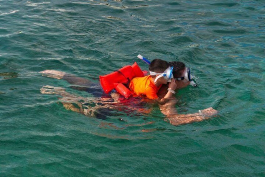 A person snorkeling in clear water. 4