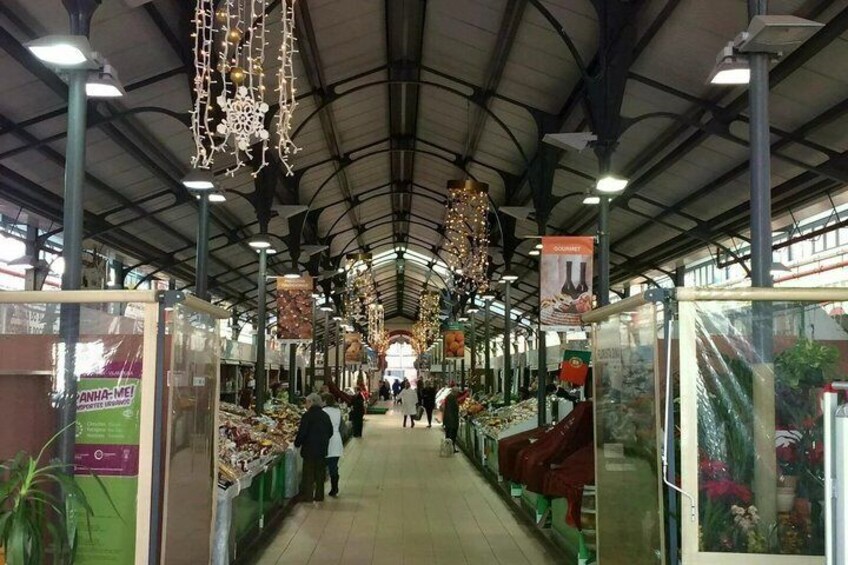An indoor market with hanging decorations and glass display cases. 5