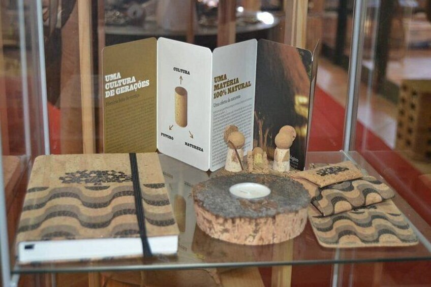 A display of ceramic tiles with a book and a sign about natural materials. 2