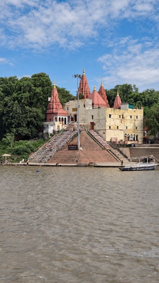 A temple with red spires and a boat docked in the foreground. 4