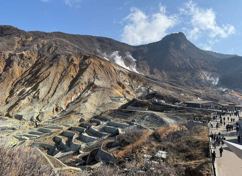 A mountainous landscape with terraced mining areas and a clear sky. 2