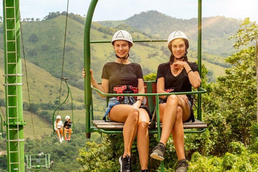 Two people on a cable car with a mountainous landscape in the background. 4