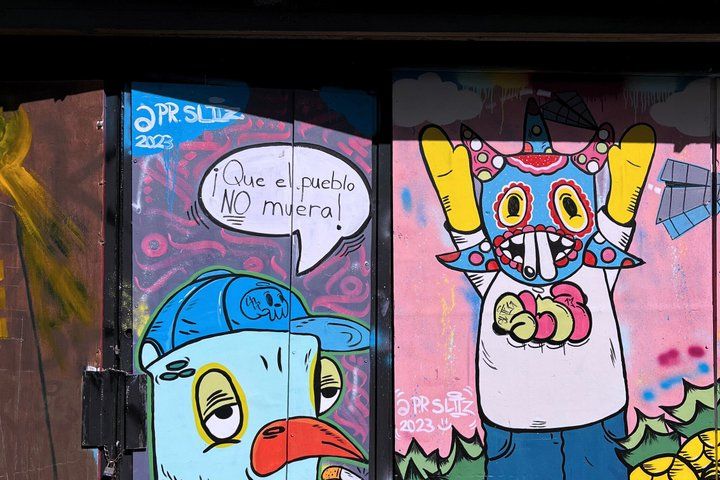 Two cartoon characters with speech bubbles on a wall. 2
