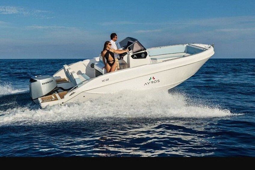 A white speedboat with 'HONDA' and 'AYROS' branding on the side, moving through the water. 4