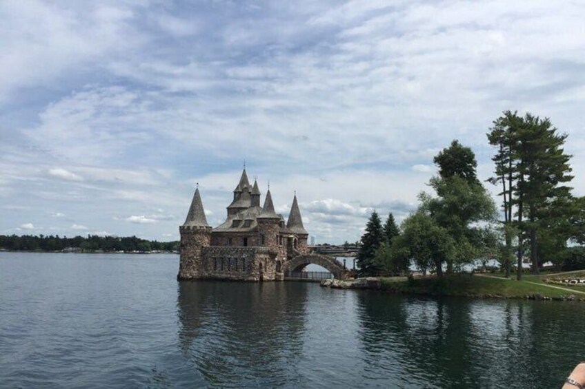 A historic castle on a lake with a bridge. 2
