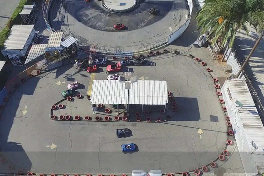 An aerial view of a roundabout with a central island, traffic cones, and a small building. 5
