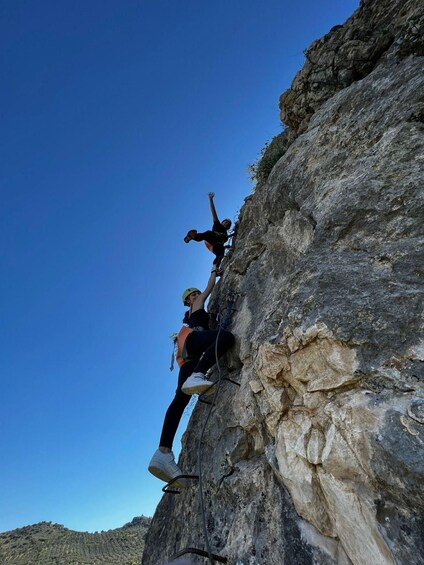 A person climbing a rocky cliff. 1