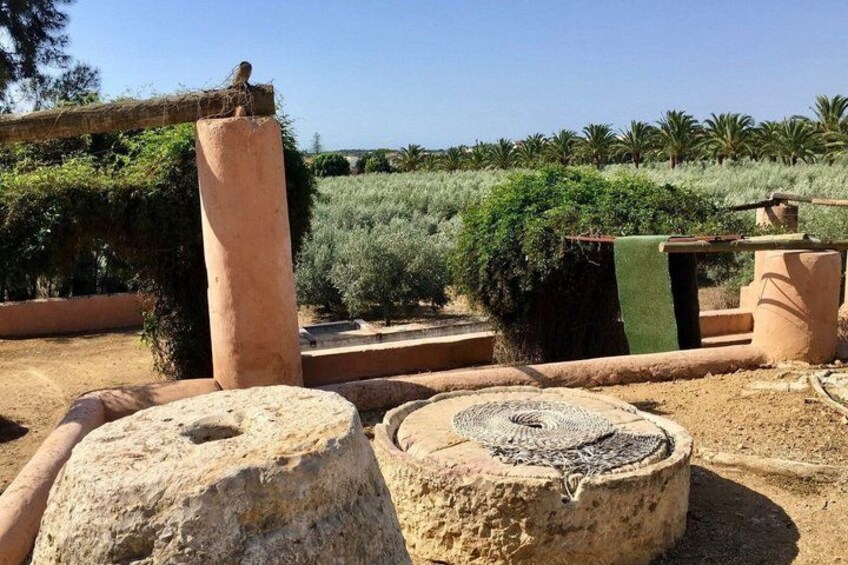 Ancient stone structures, a large stone with a hole, and a circular stone with a pattern. 4