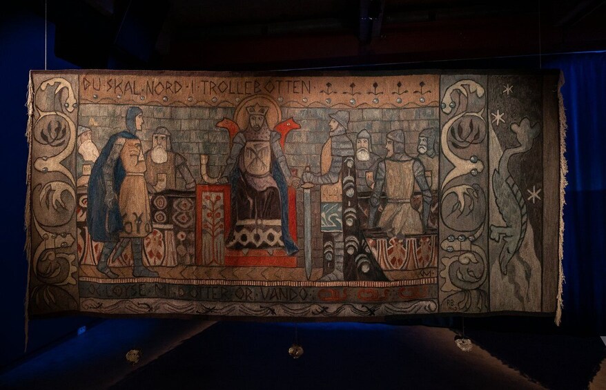 A medieval tapestry with figures, text, and decorative borders. 3