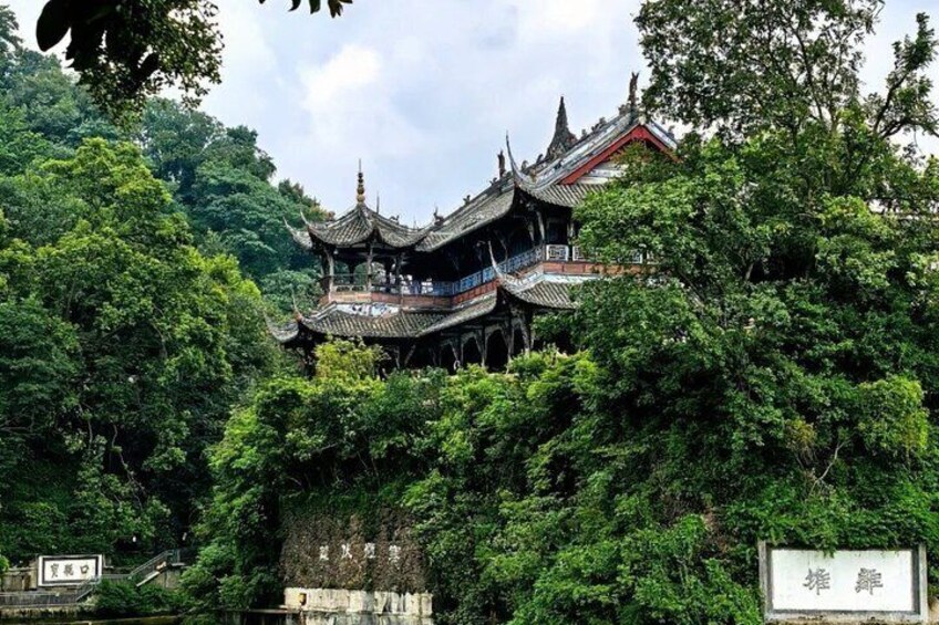 A traditional Chinese pagoda surrounded by lush greenery. 4