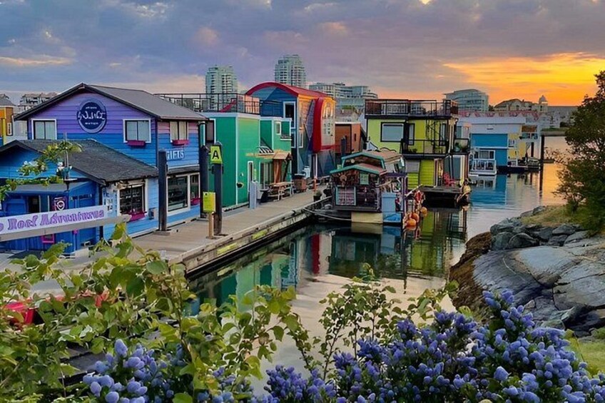 Colorful buildings along a waterfront with a calm body of water reflecting the structures. 4