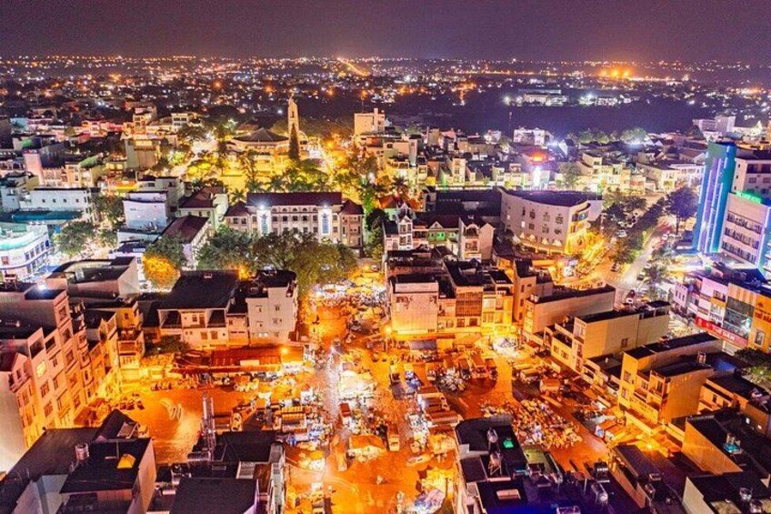 A cityscape at night with illuminated buildings and streets. 5