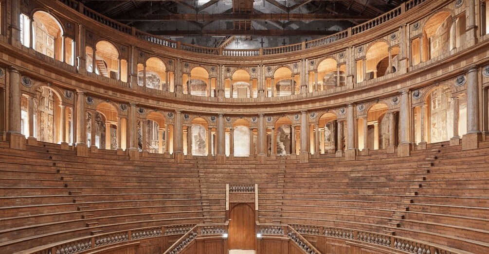 A grand, circular auditorium with tiered seating and ornate columns. 1
