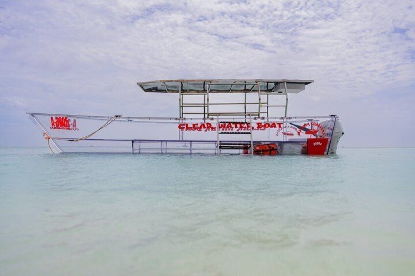 A stationary boat with a canopy and the text 'CLEAN WATER BOAT' in the water. 2