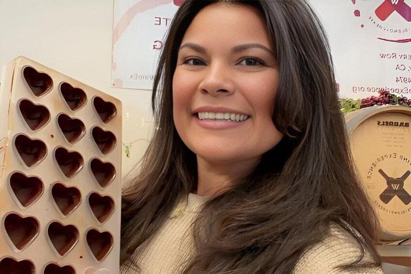 A person holding a heart-shaped chocolate mold. 3