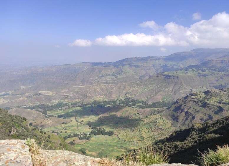 A mountainous landscape with terraced fields and a clear sky. 5