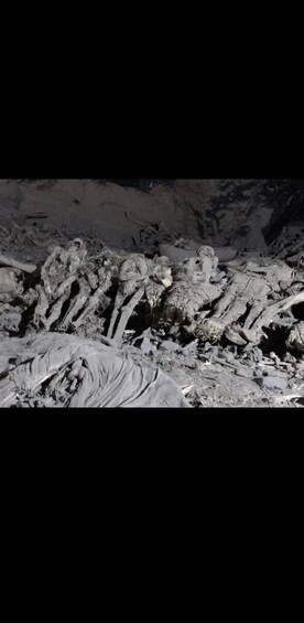 A cave with skeletal remains and artifacts. 3