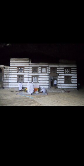 A traditional building with a tiled floor and a person standing at the entrance. 2