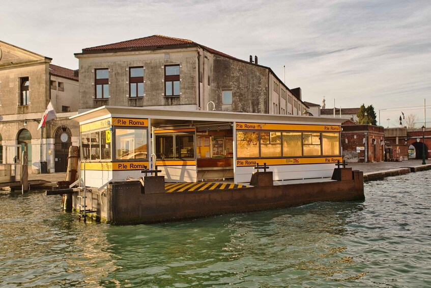 A boat named 'Ple Roma' docked at a pier with buildings in the background. 5