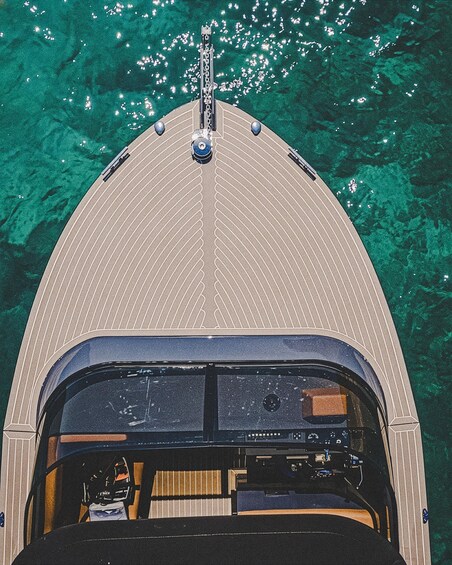 A boat's bow and cabin with clear water around. 2