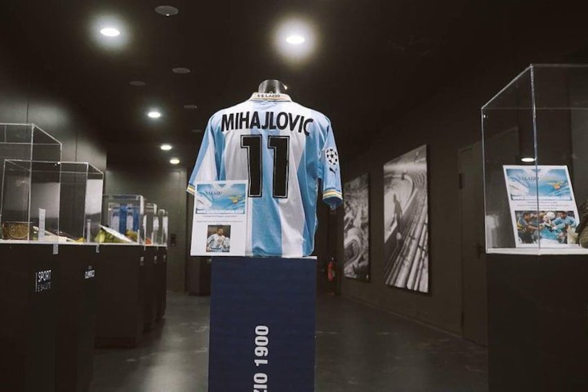 A sports jersey on a display stand with the name 'MIHAJLOVIC' and the number '11' on the back. 5