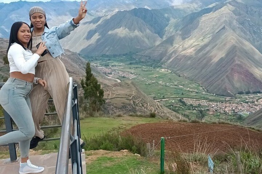 Two people posing with a scenic mountain landscape in the background. 4