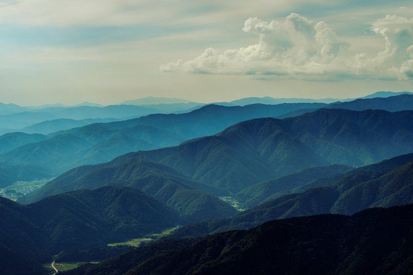 A mountainous landscape with layered hills and a valley. 4